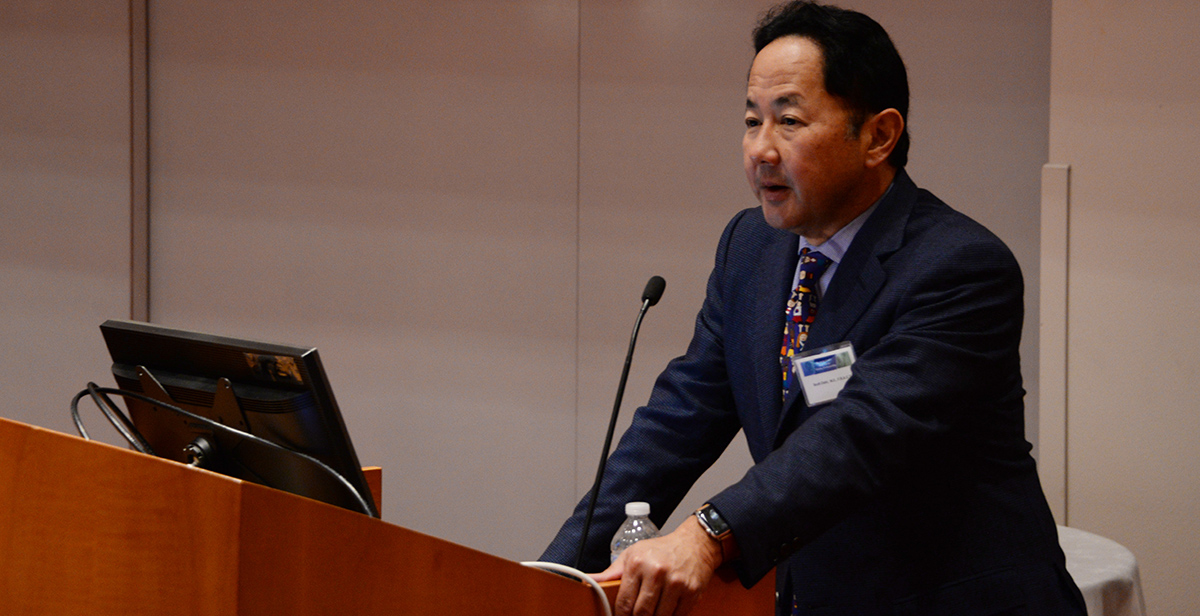Dr. Oishi presenting at a conference.