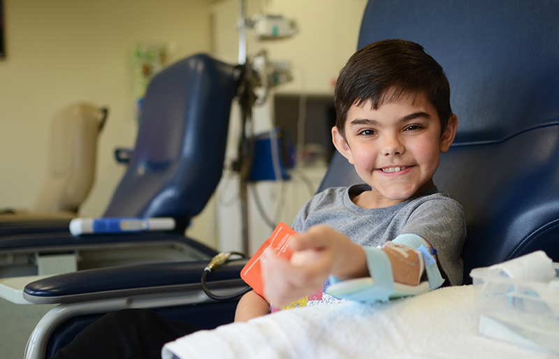 Pediatric rheumatology patient smiling during visit at Texas Scottish Rite Hospital for Children 