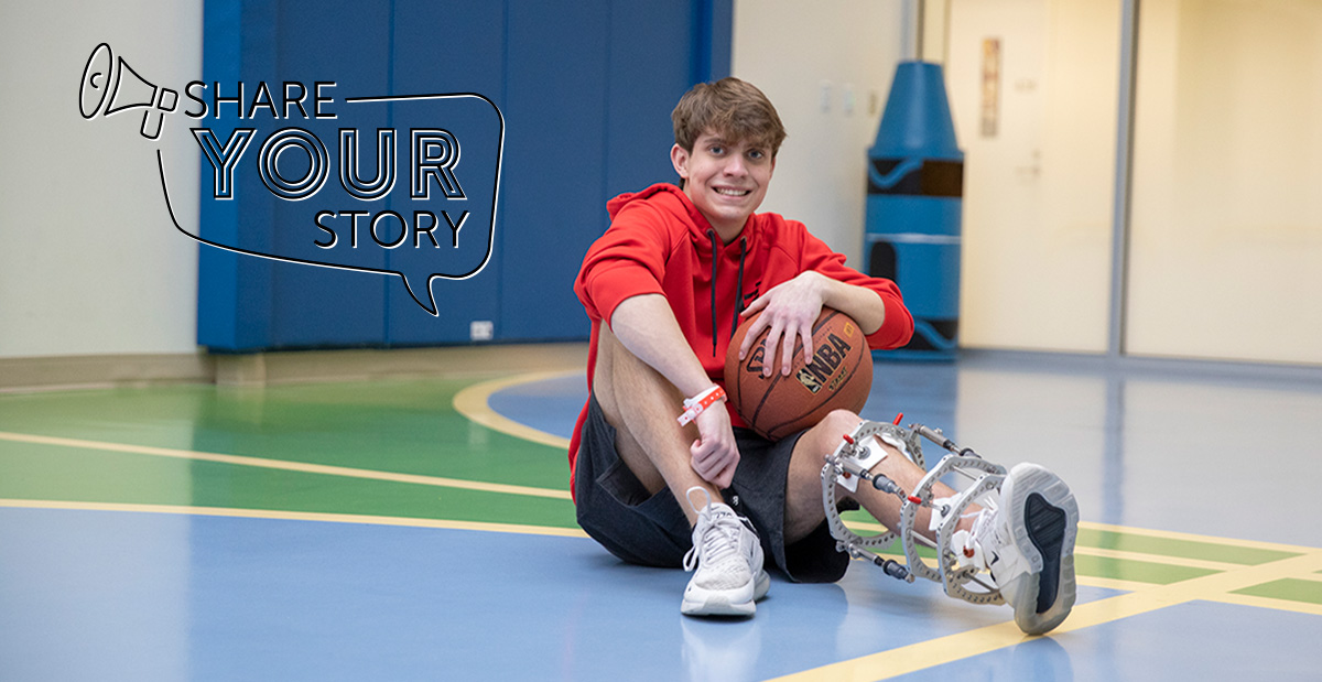 boy in gym with external fixator and basketball
