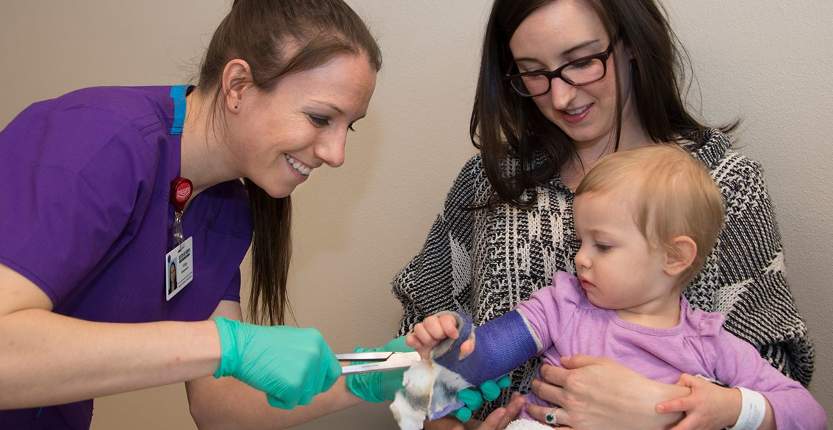 Texas Scottish Rite Hospital for Children Fracture Clinic nurse removes cast from small child