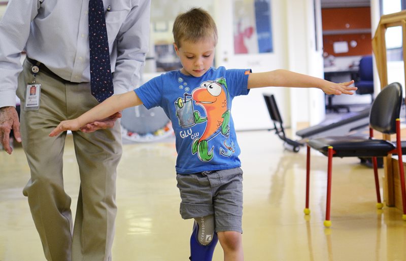 Doctor helps young boy with prosthetic leg walk at Texas Scottish Rite Hospital for Children