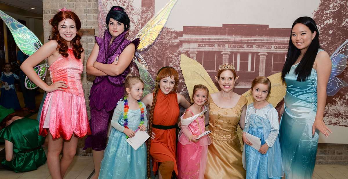 Patients at Texas Scottish Rite Hospital for Children pose with princesses