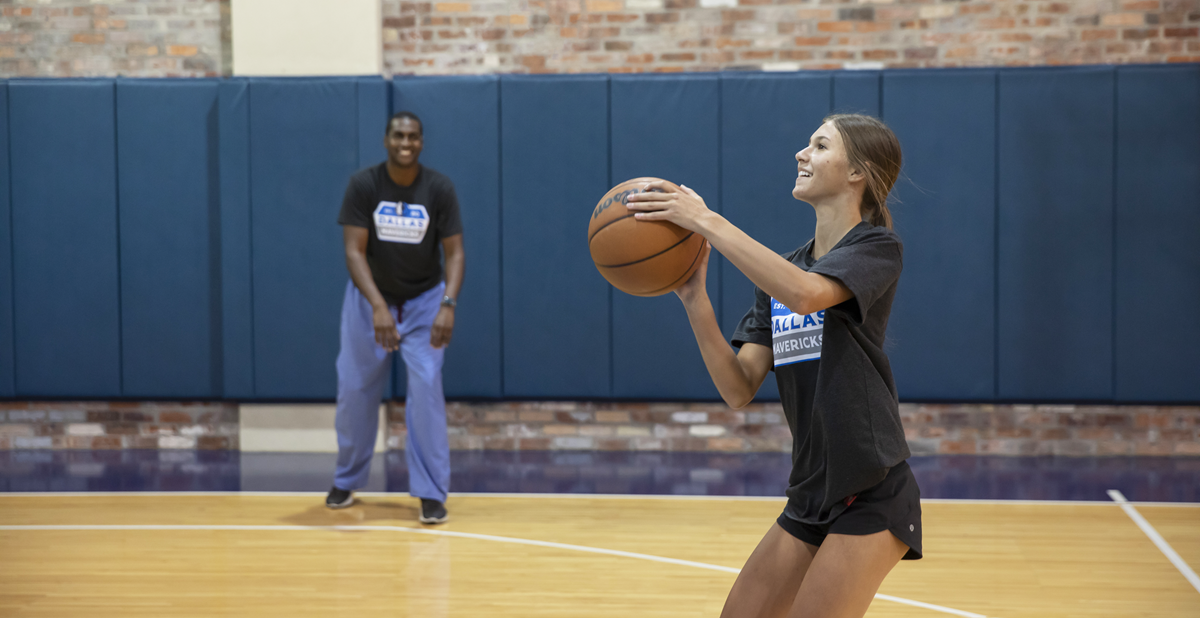 Dr. Brooks and patient, Gracee, playing basketball