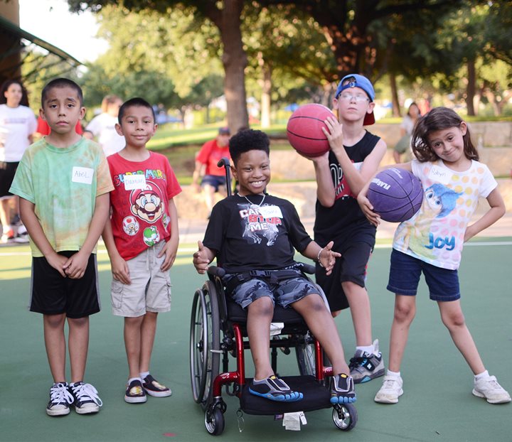 Teenage boy in wheelchair playing in basketball league provided by the Therapeutic Recreation department at Texas Scottish Rite Hospital for Children