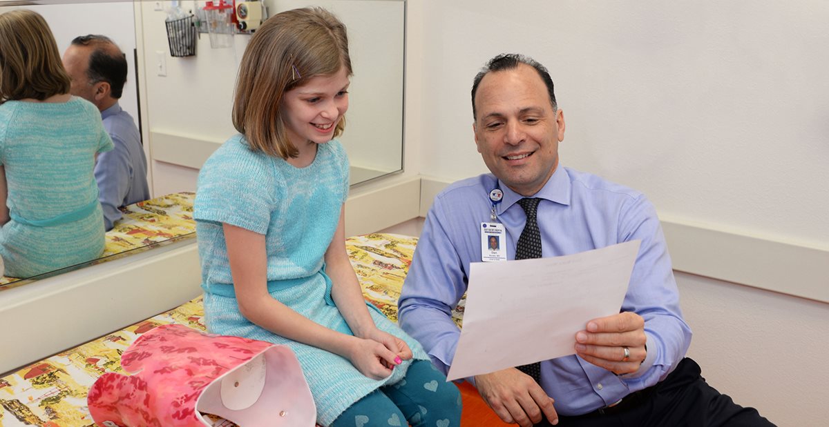 Texas Scottish Rite Hospital for Children doctor reviews diagnosis with patient 