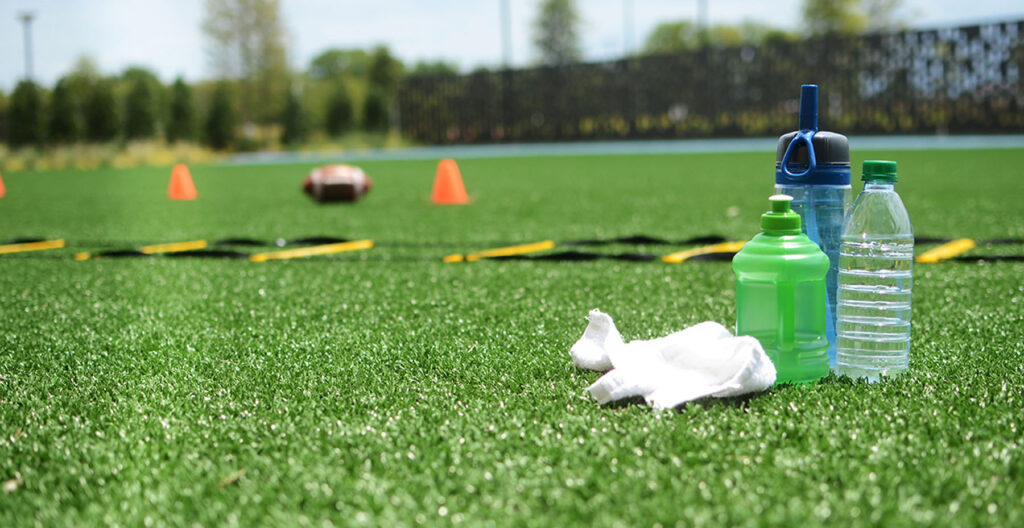 Water bottles and towel on field