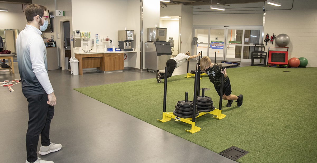 baseball players working with therapists in the gym