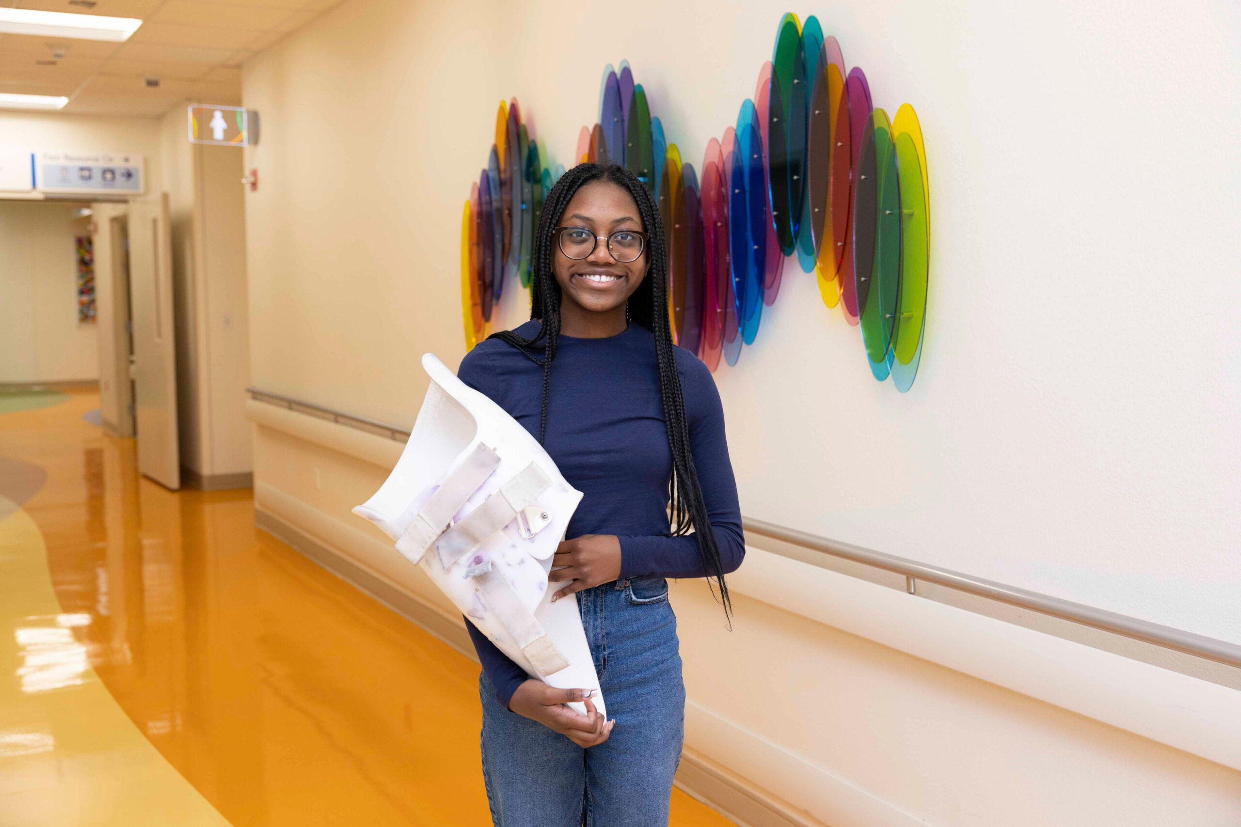 Teenage girl posing with her scoliosis brace.