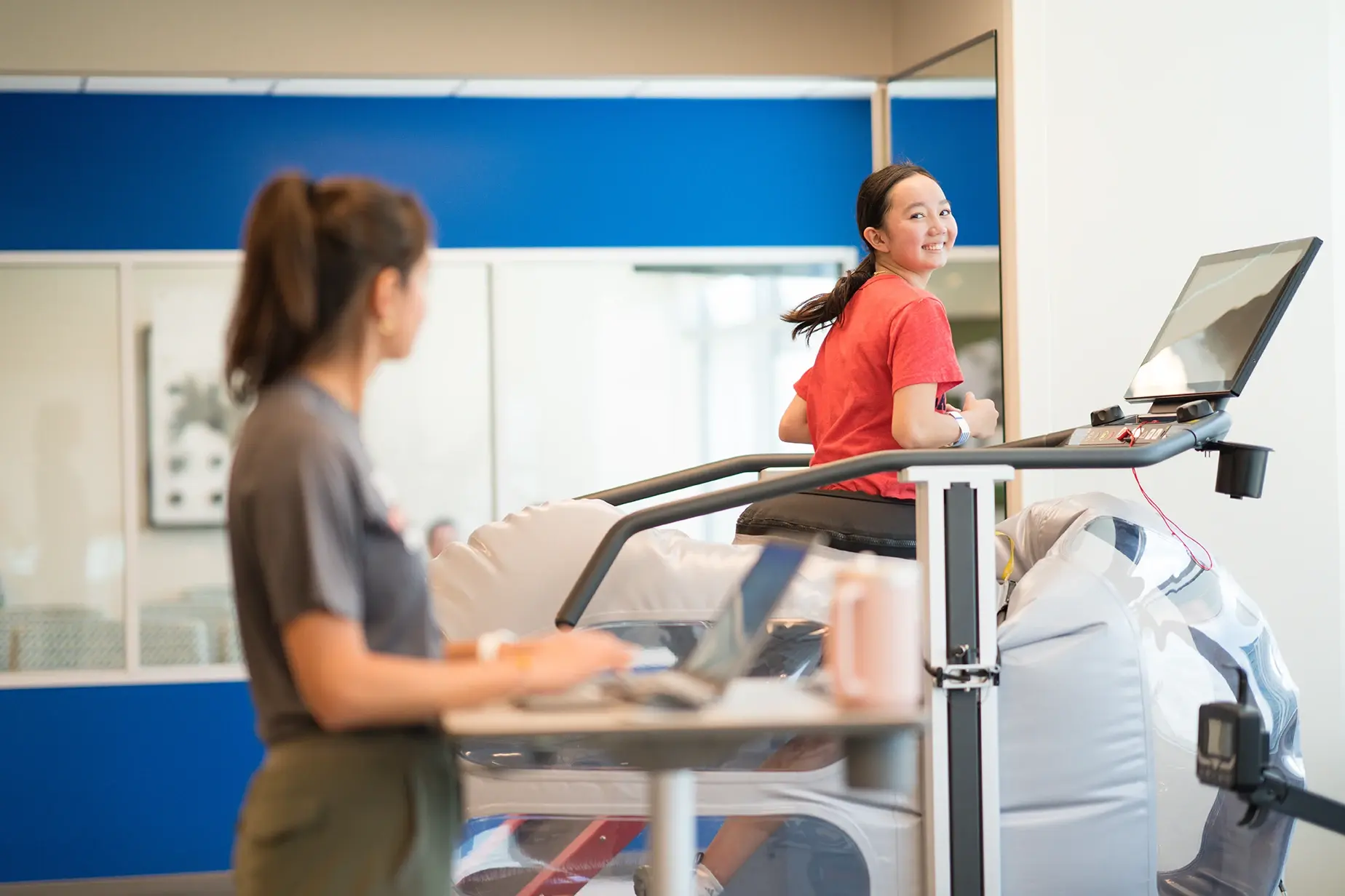 Sarah Kim working with a physical therapist.