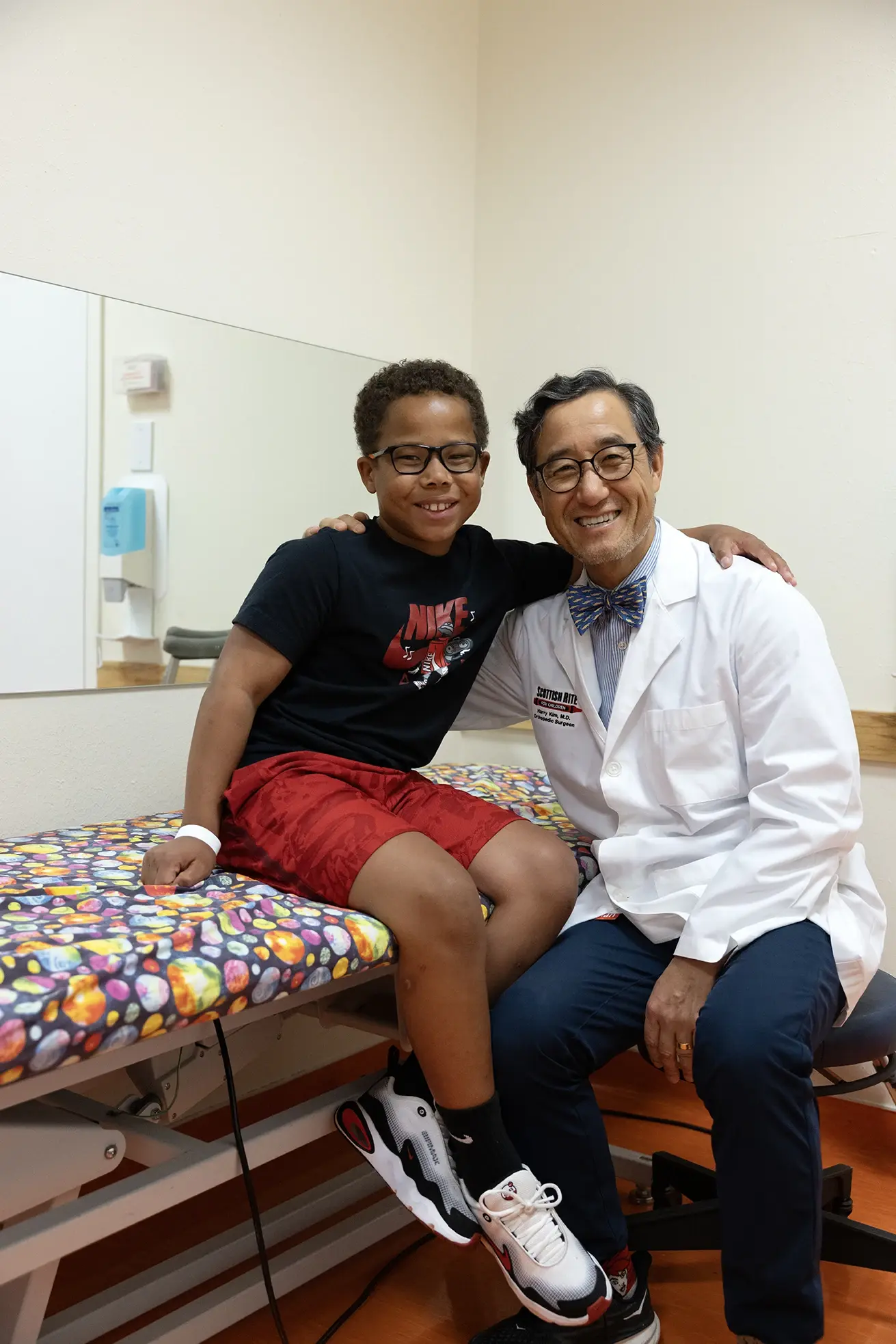 Dr. Henry Kim smiling with a hip care patient.