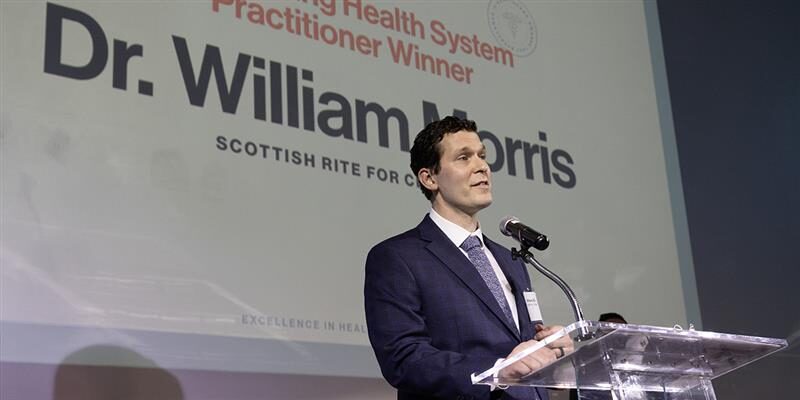 Doctor William Morris is accepting an award.