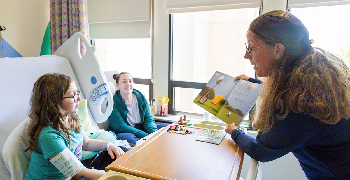 Patient Norah engages in a creative intervention with Jerilynn Putnam as her, Julie, observes. 