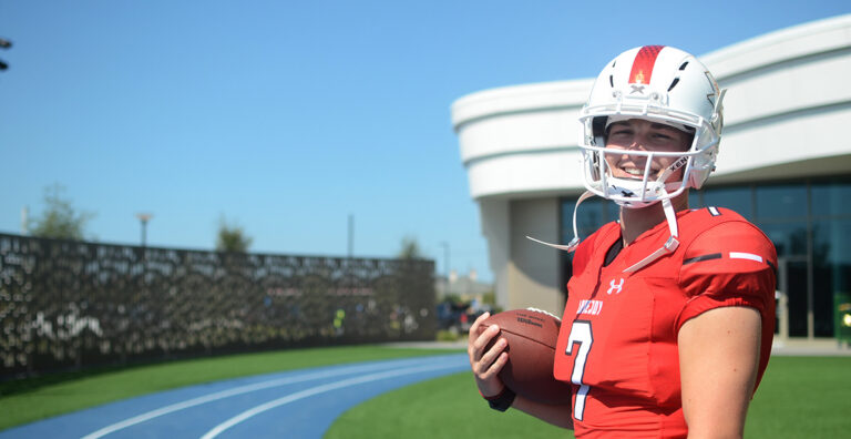 Boy with football helmet is smiling